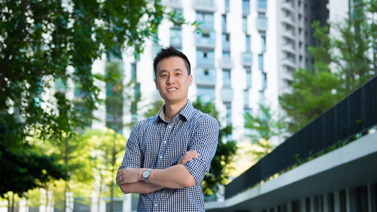 Jonathan Lui in front of a building and trees