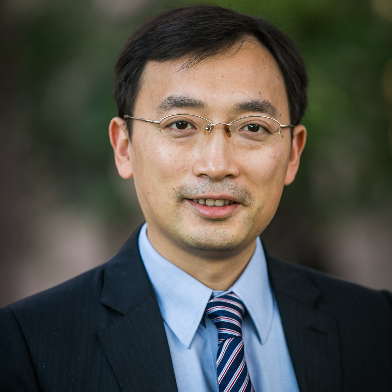 Professor Heng Wang, wearing black suit and a blue strip tie