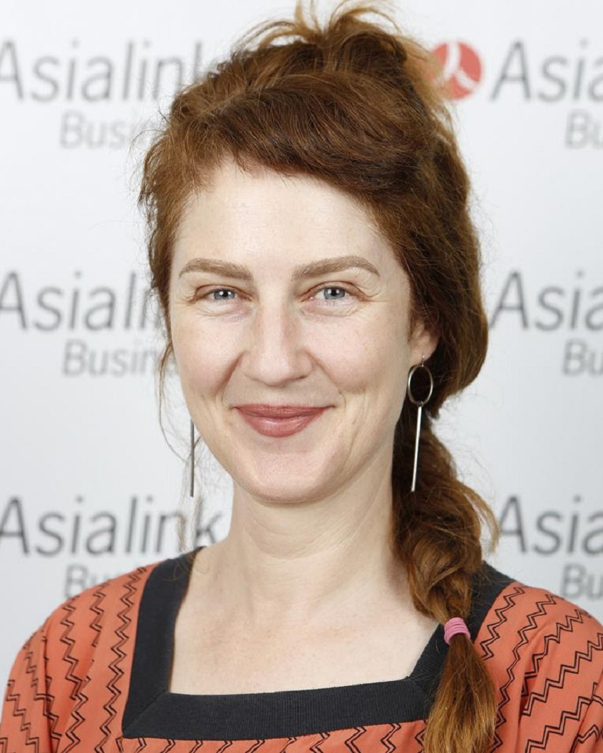 A photo of Hannah Matthews wearing an orange shirt.