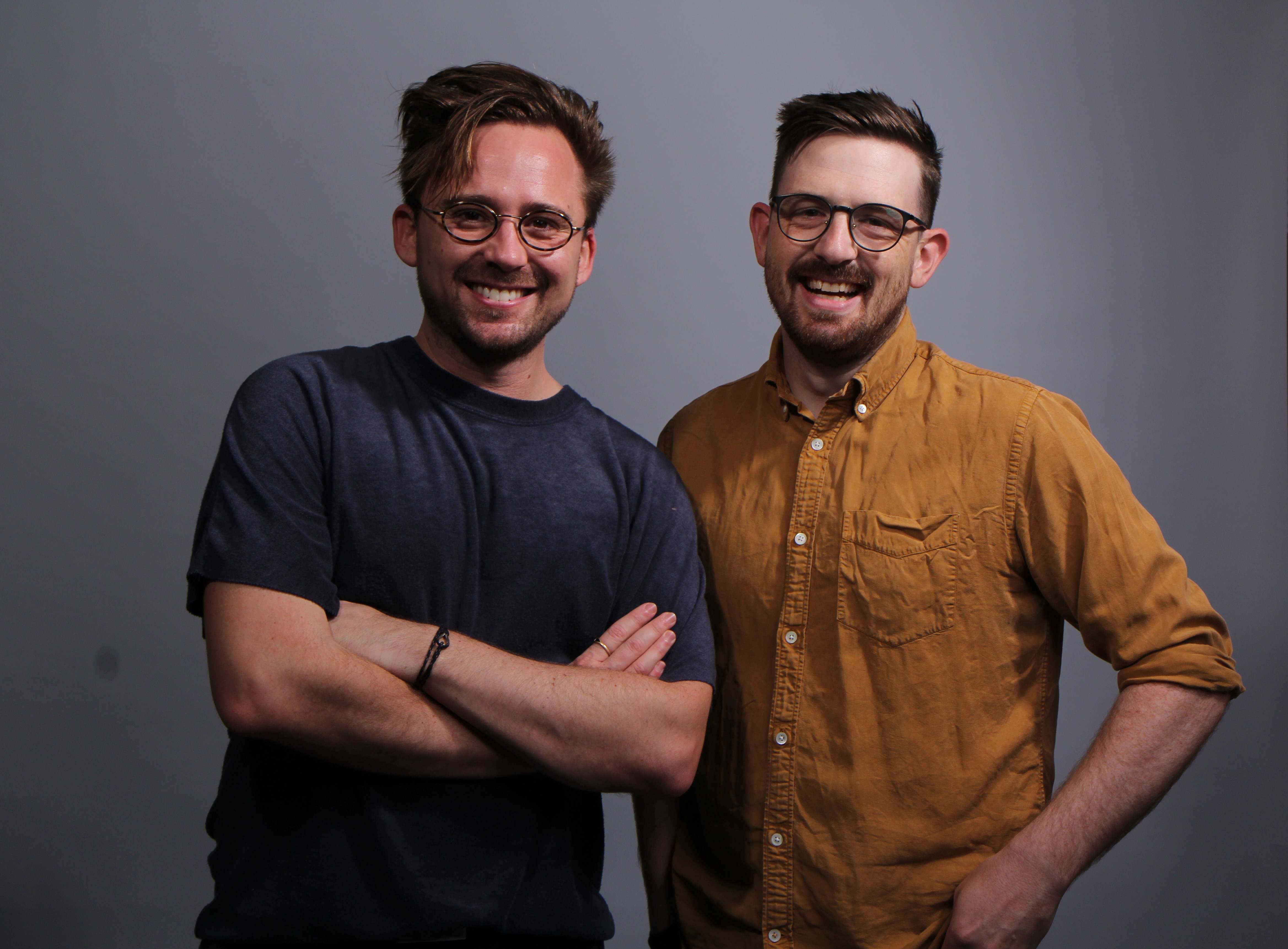 Two men standing and posing for photo.