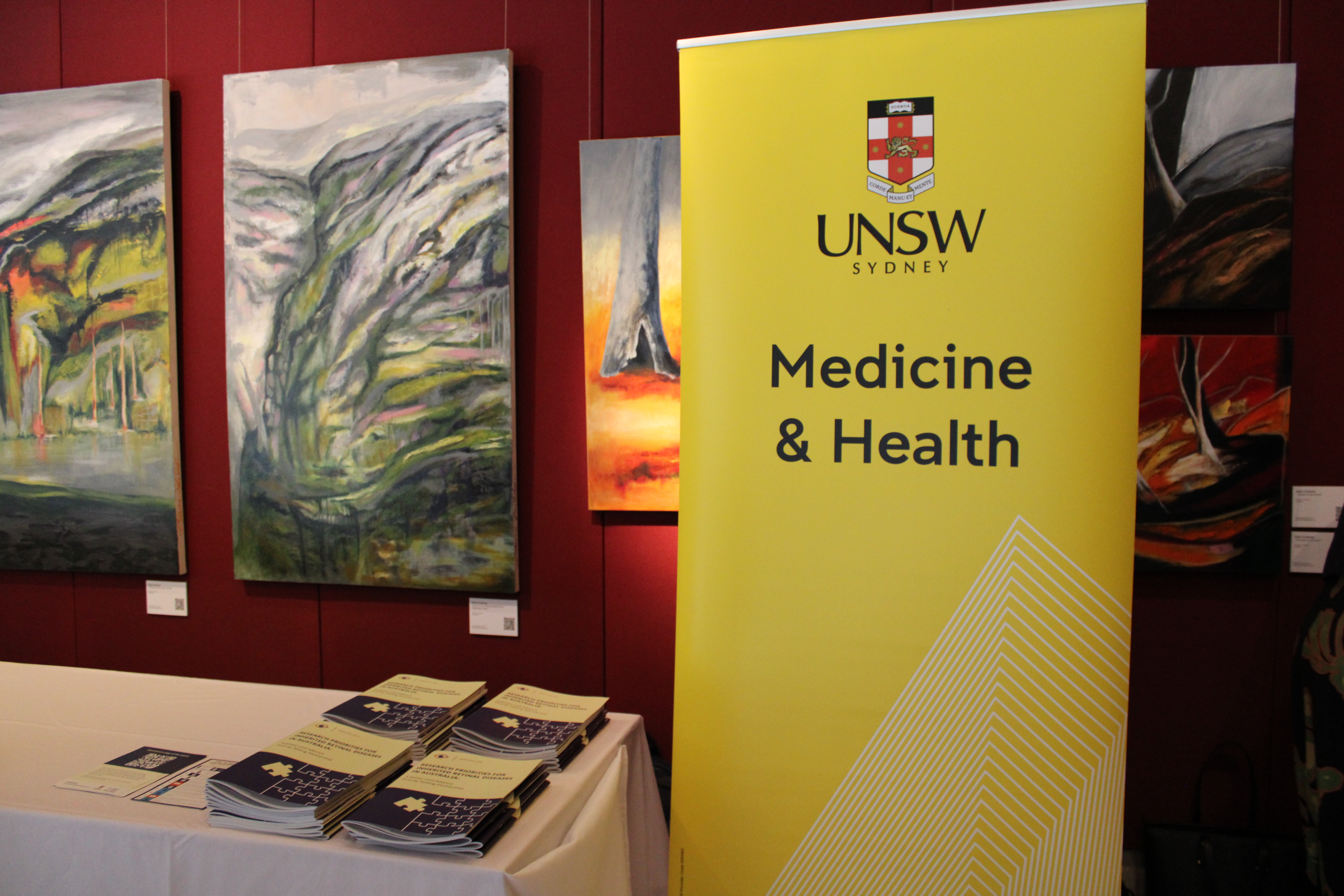 Image of a UNSW Medicine & Health banner, with some reports on a table.