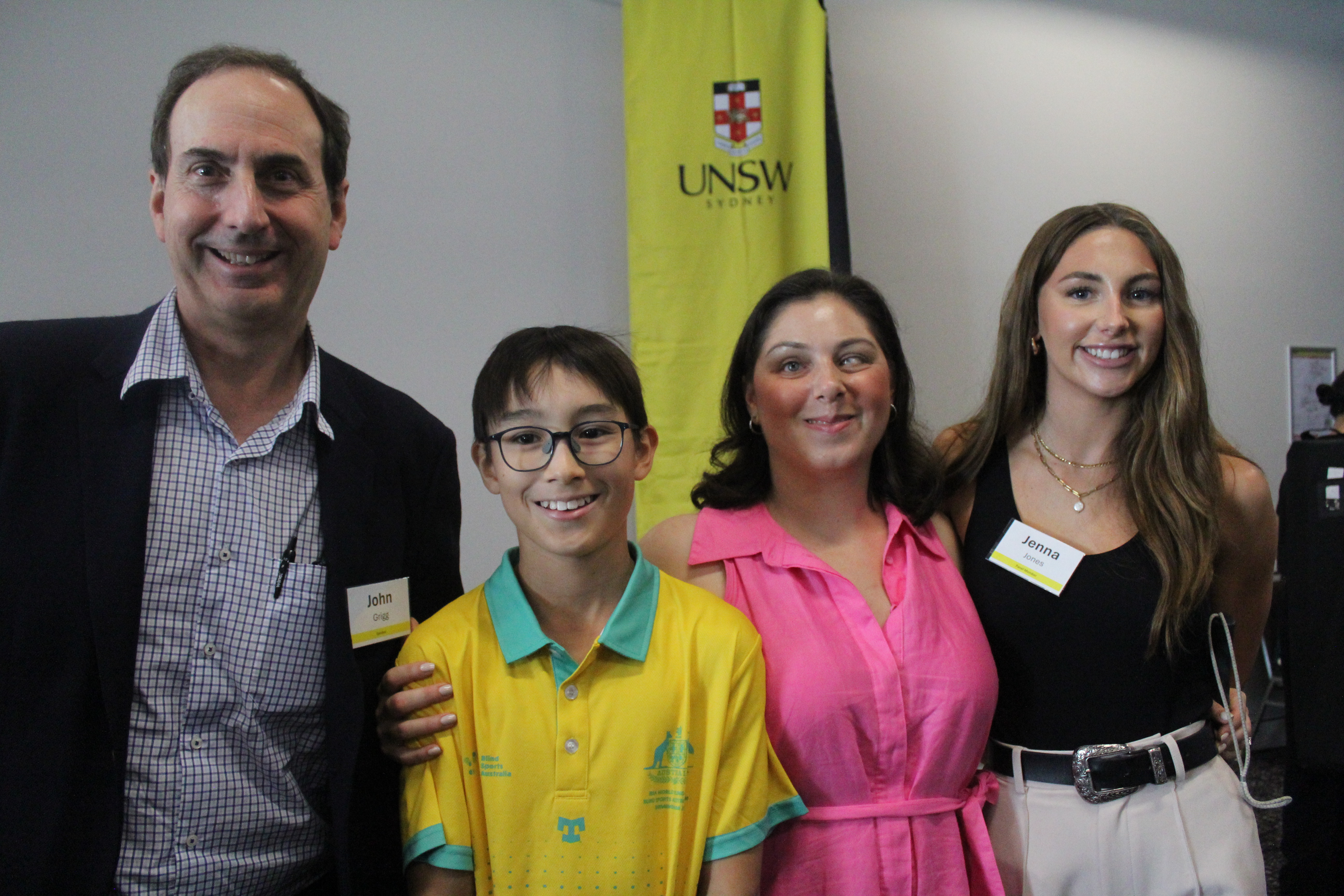 Image of four people smiling at the camera