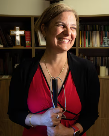 Photo of Liliana holding her cane 
