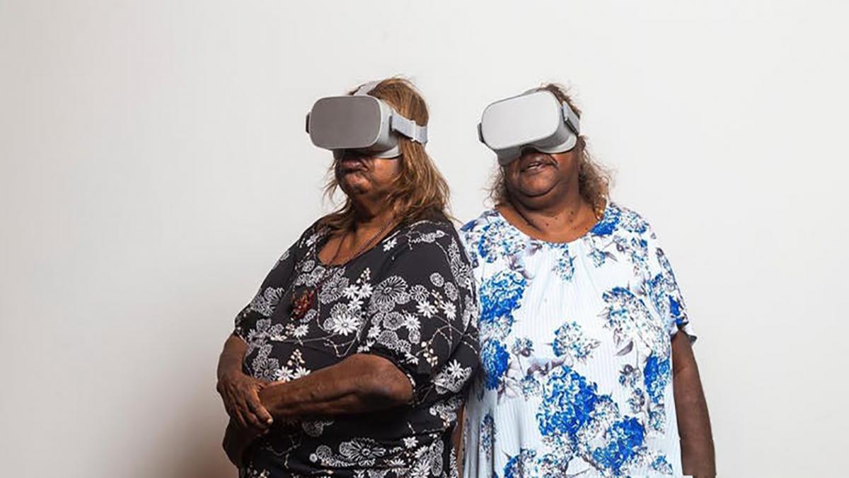 Two women wearing VR goggles