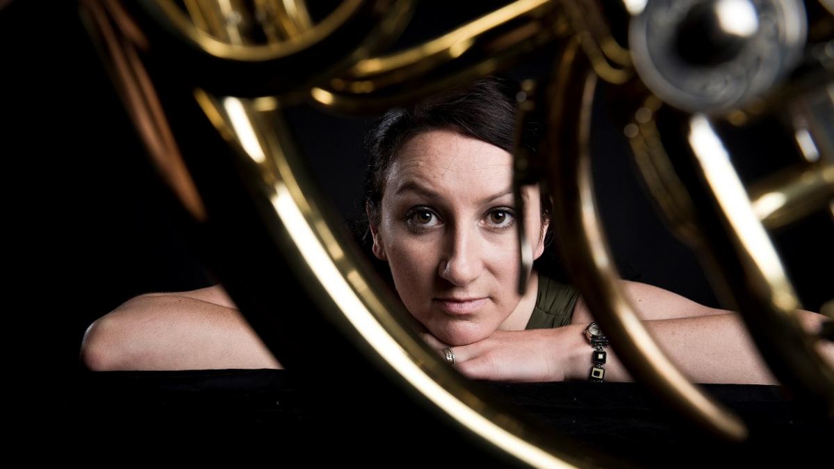 artistic photo of Carla Blackwood looking through a horn