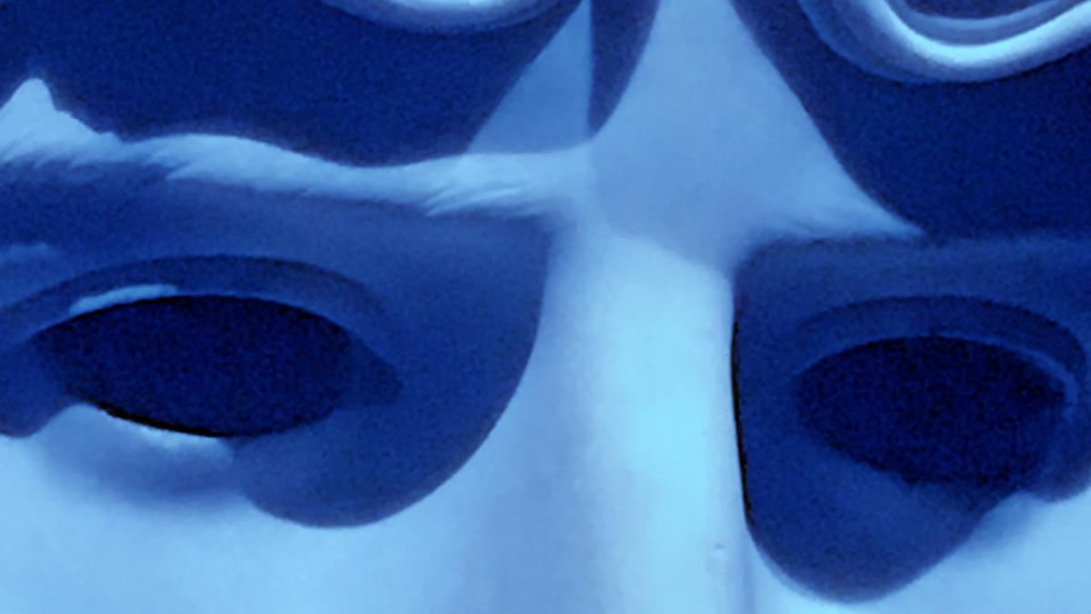 close up photography of blue-coloured sculpture of a man's face