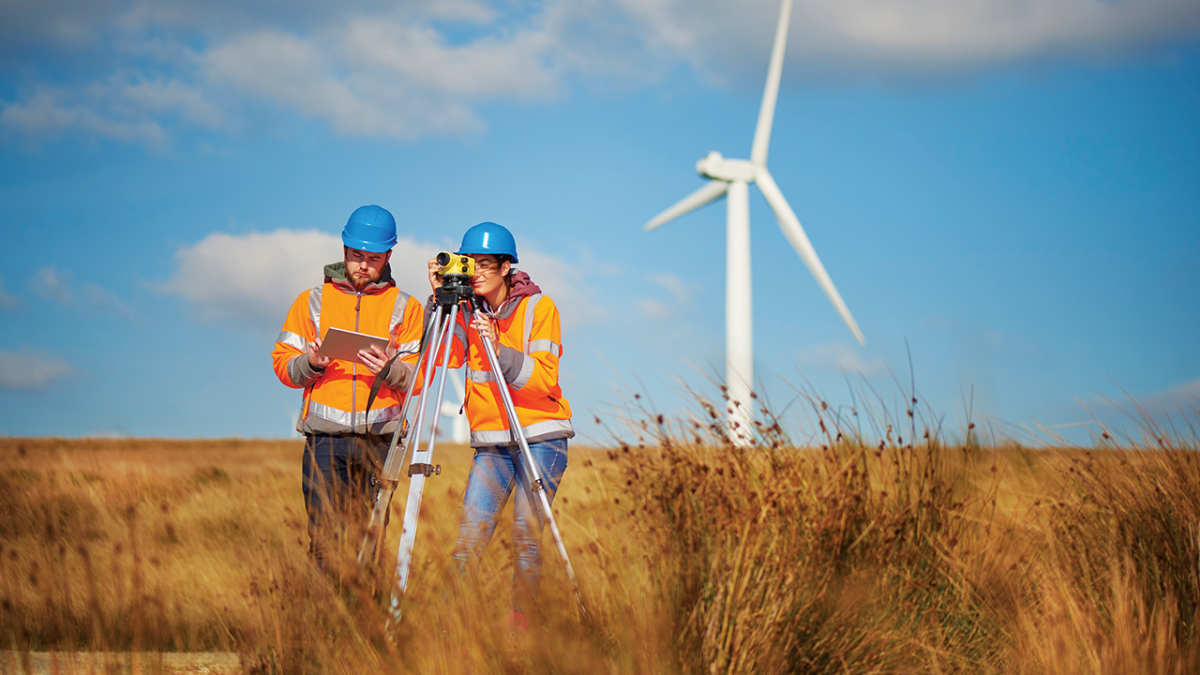Image of two people in a windmill farm