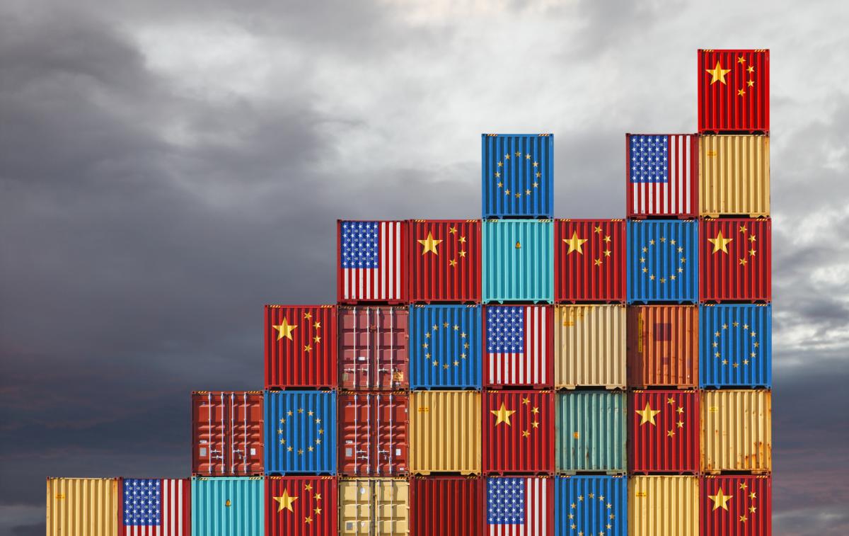 Stacks of shipping containers, painted in the flags of the US, China, and the EU