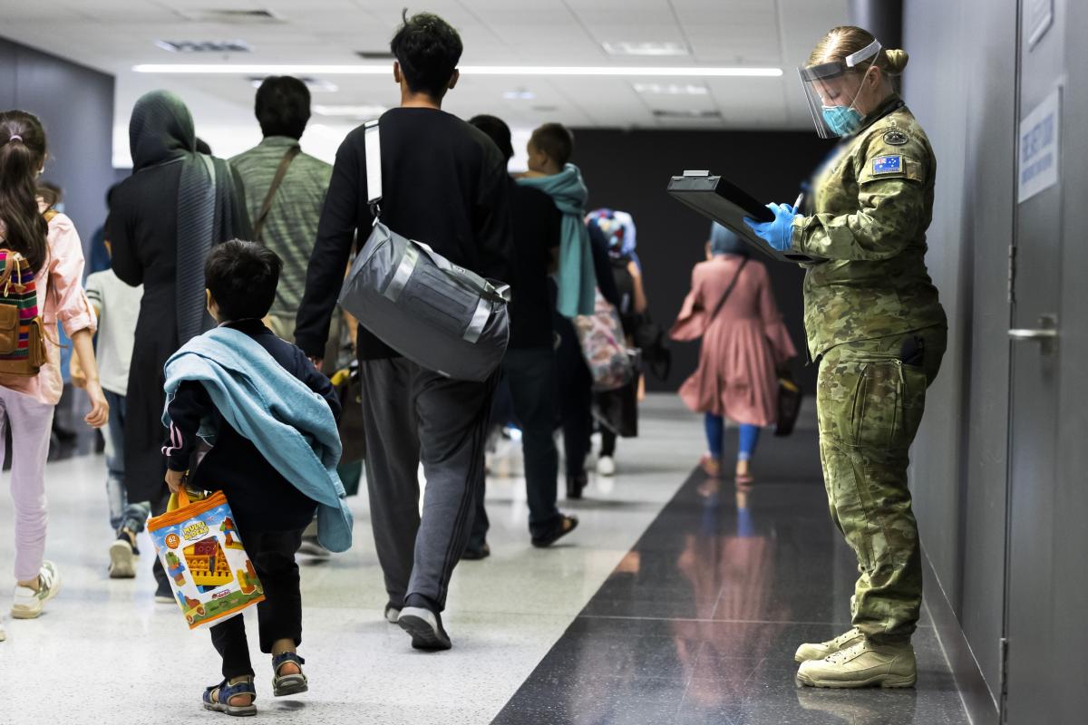 Image credit: CPL Dustin Anderson / Defence Media Caption:  Australian Army Private Jemma Fulton assists Australian citizens and visa holders evacuated from Afghanistan off their flight into Australia.  File Date: 2021-08-31 