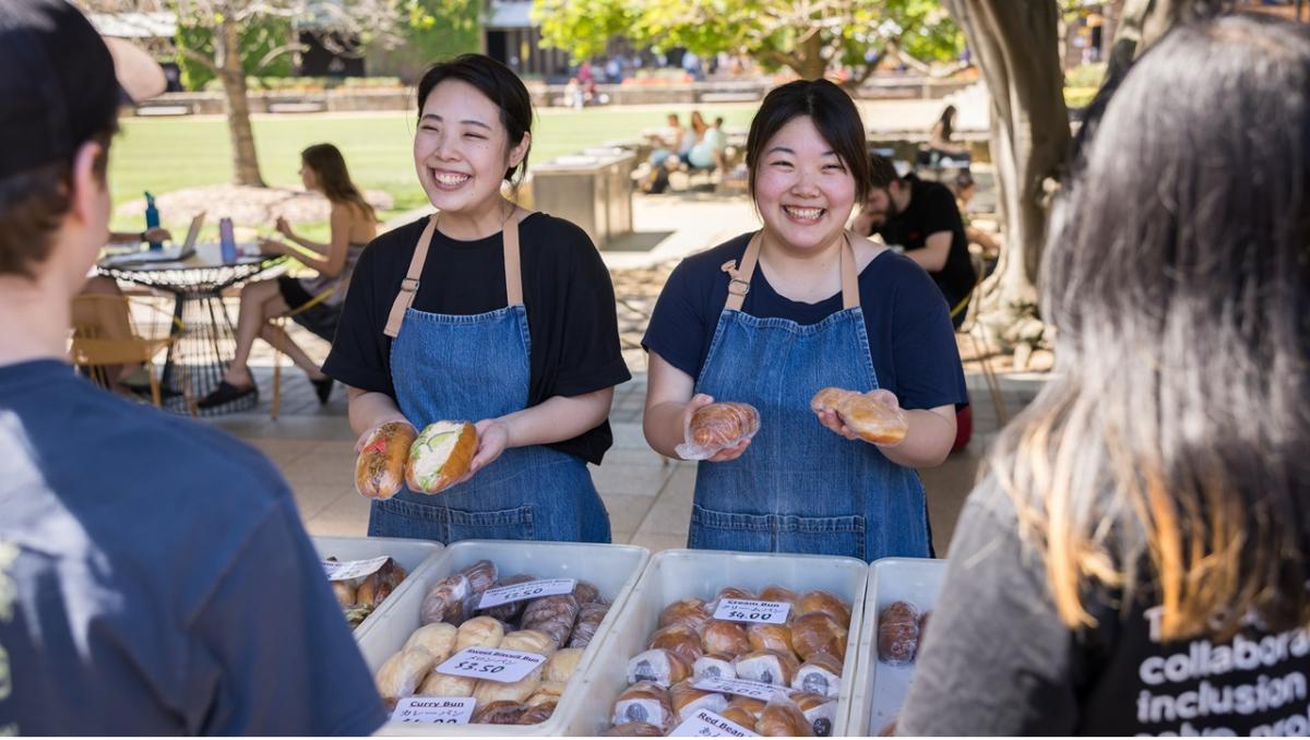 Two women serving at a market stall