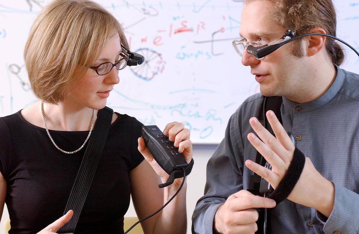 Two people communicating with smartglasses