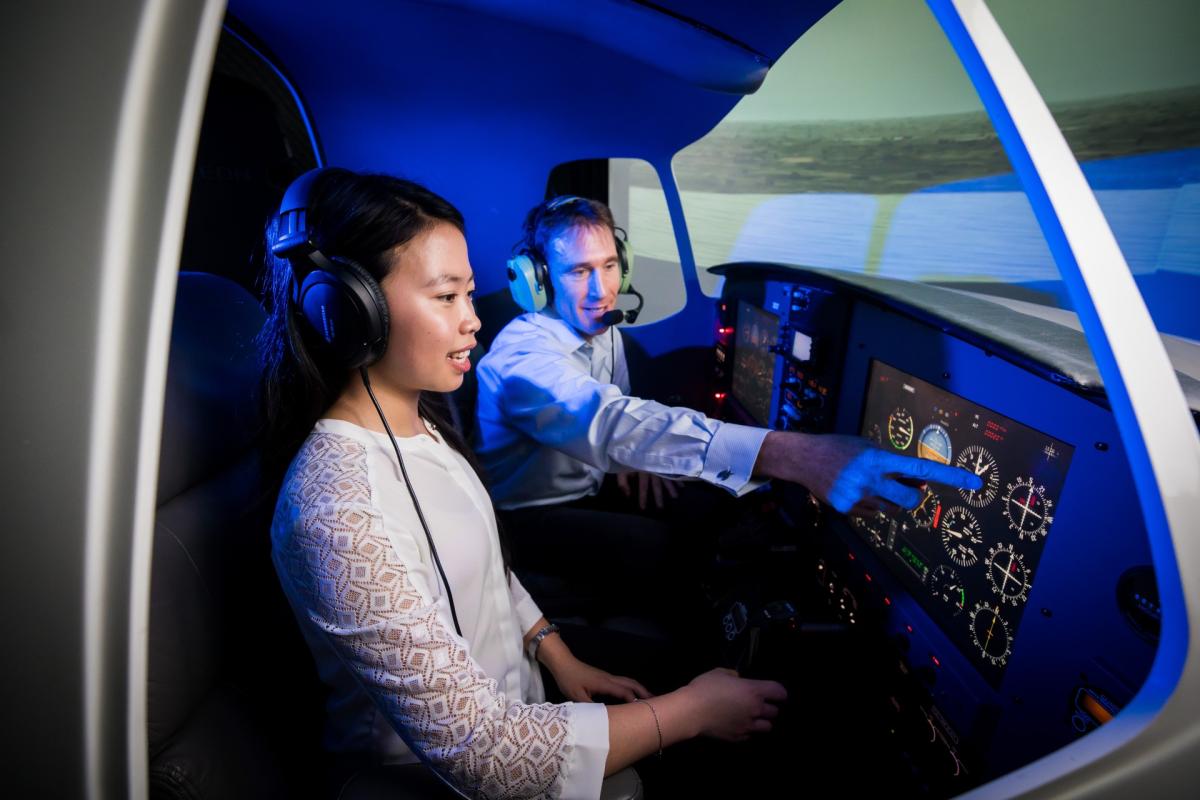 Two Aviation students inside the flight simulator 
