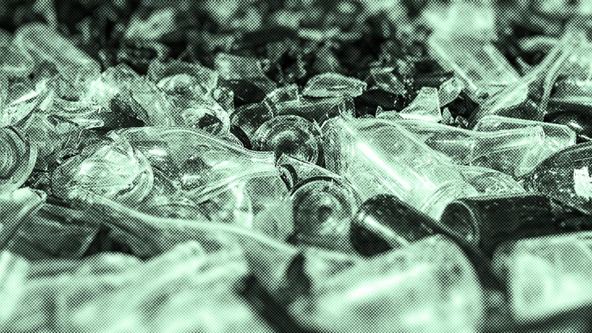 An image of broken glass bottles in landfill