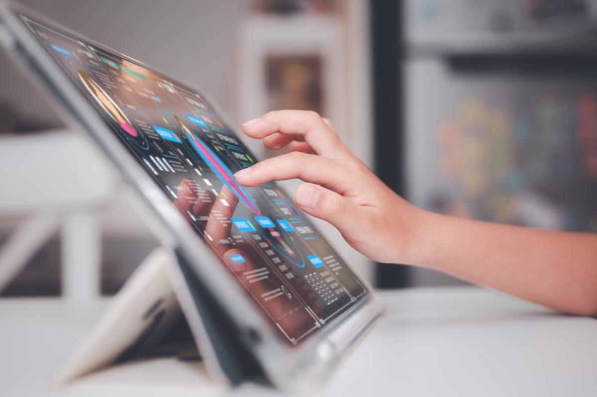 Child interacting with digital screen.