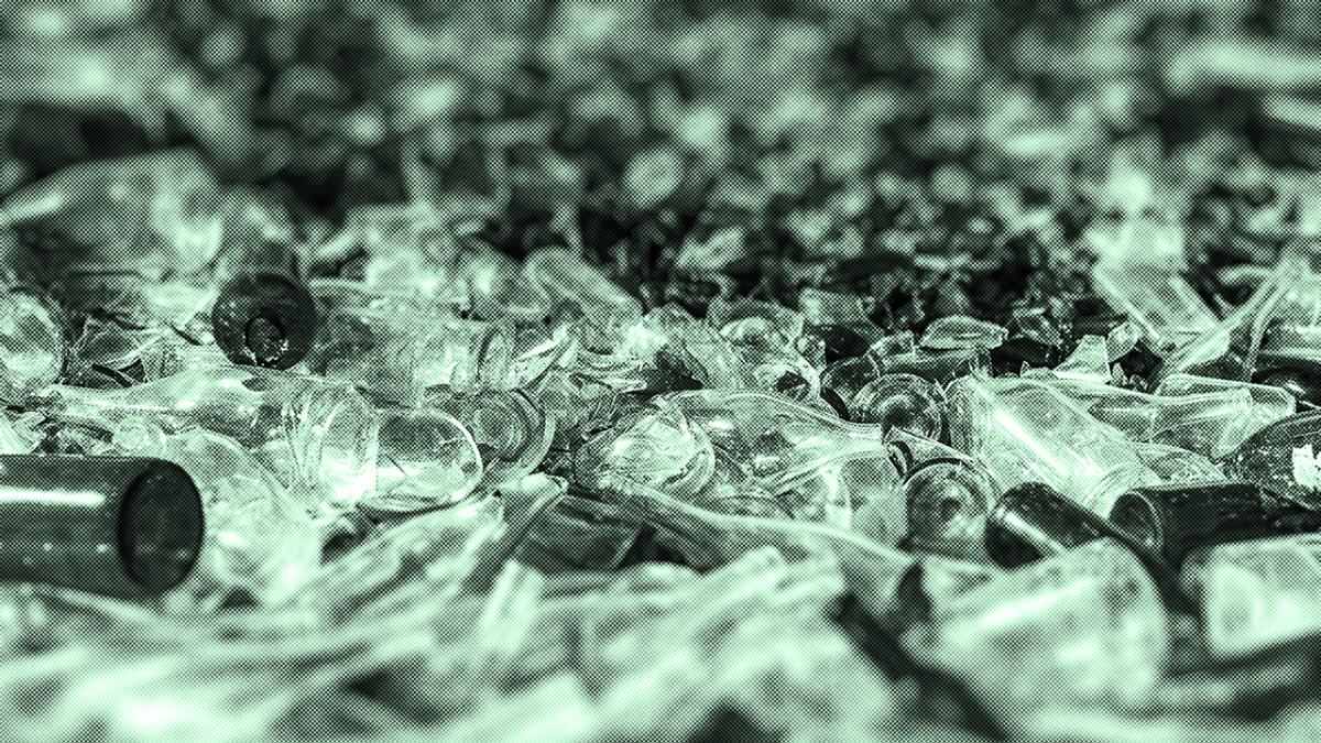 A large pile of discarded green glass bottles