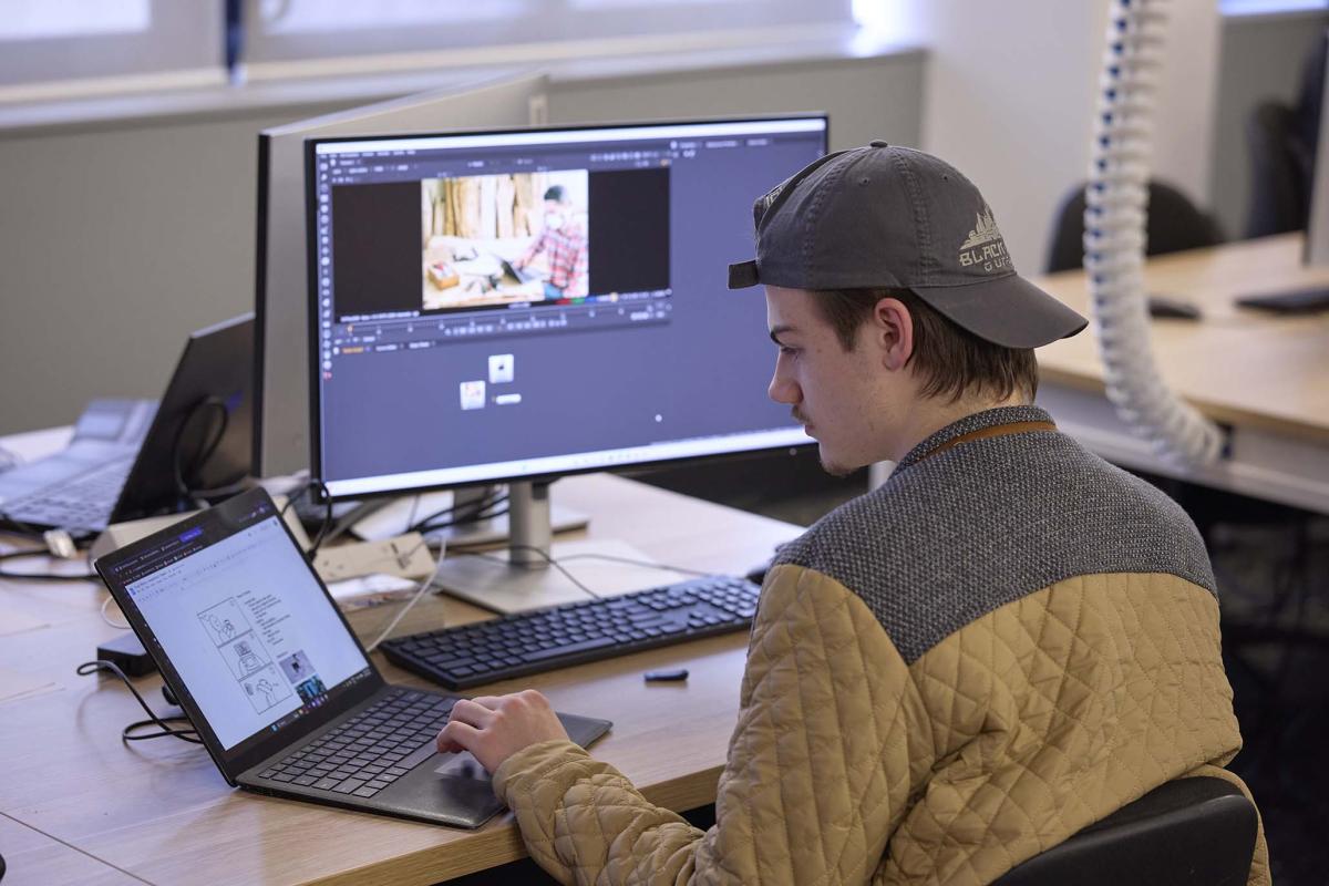 Male student using visual effects software 