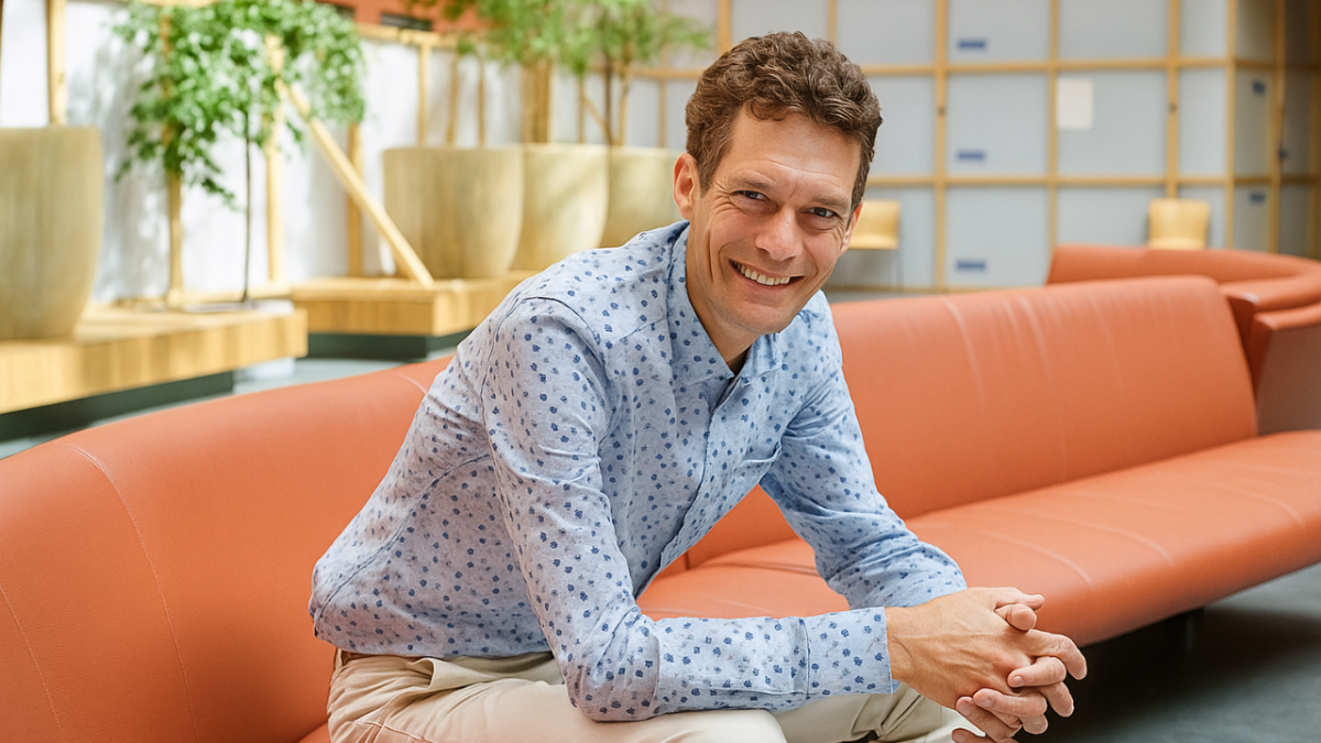 A person smiling while sat down