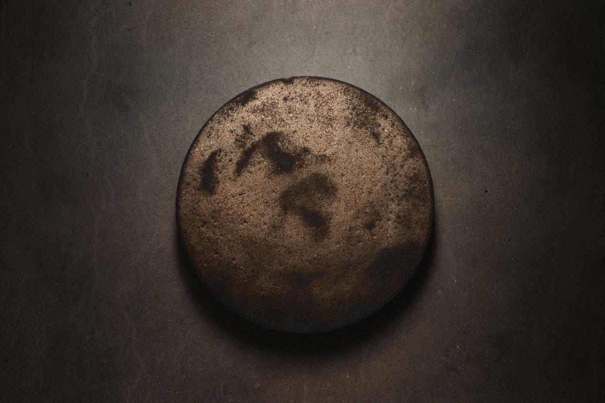 ceramic disk on dark wall